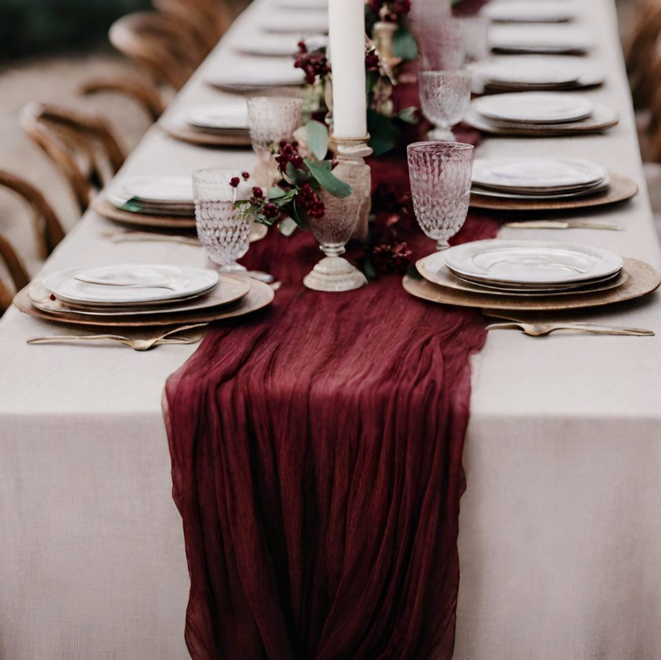 Table set with burgundy table runner and crystal glassware