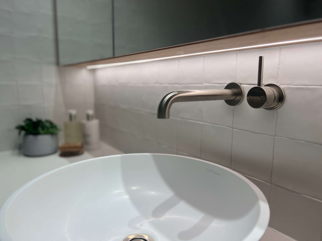 White basin with brushed nickel tapware