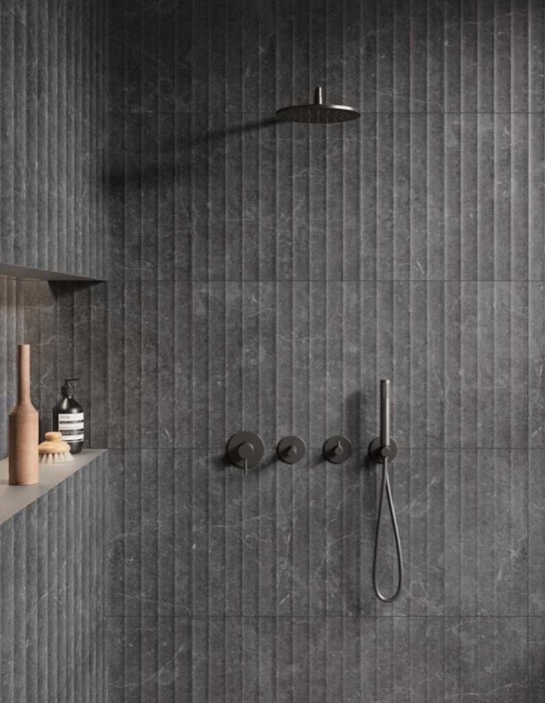 Gunmetal Grey tapware against fluted grey tiled shower 
