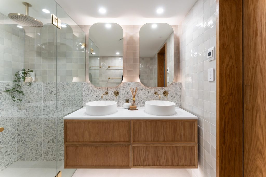Coastal bathroom with wooden vanity in a full apartment renovation in Manly, Northern Beaches, Sydney.